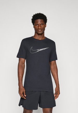 Black Nike T-shirt with a white swoosh graphic. Short sleeves, round neckline, made of smooth fabric. Worn with dark athletic shorts.