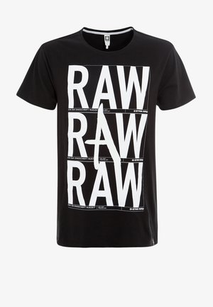 Schwarzes T-Shirt mit kurzen Ärmeln und großem weißem fettem "RAW"-Schriftzug, der dreimal vertikal auf der Vorderseite gedruckt ist, mit einem stilisierten Buchstaben A in der Mitte.