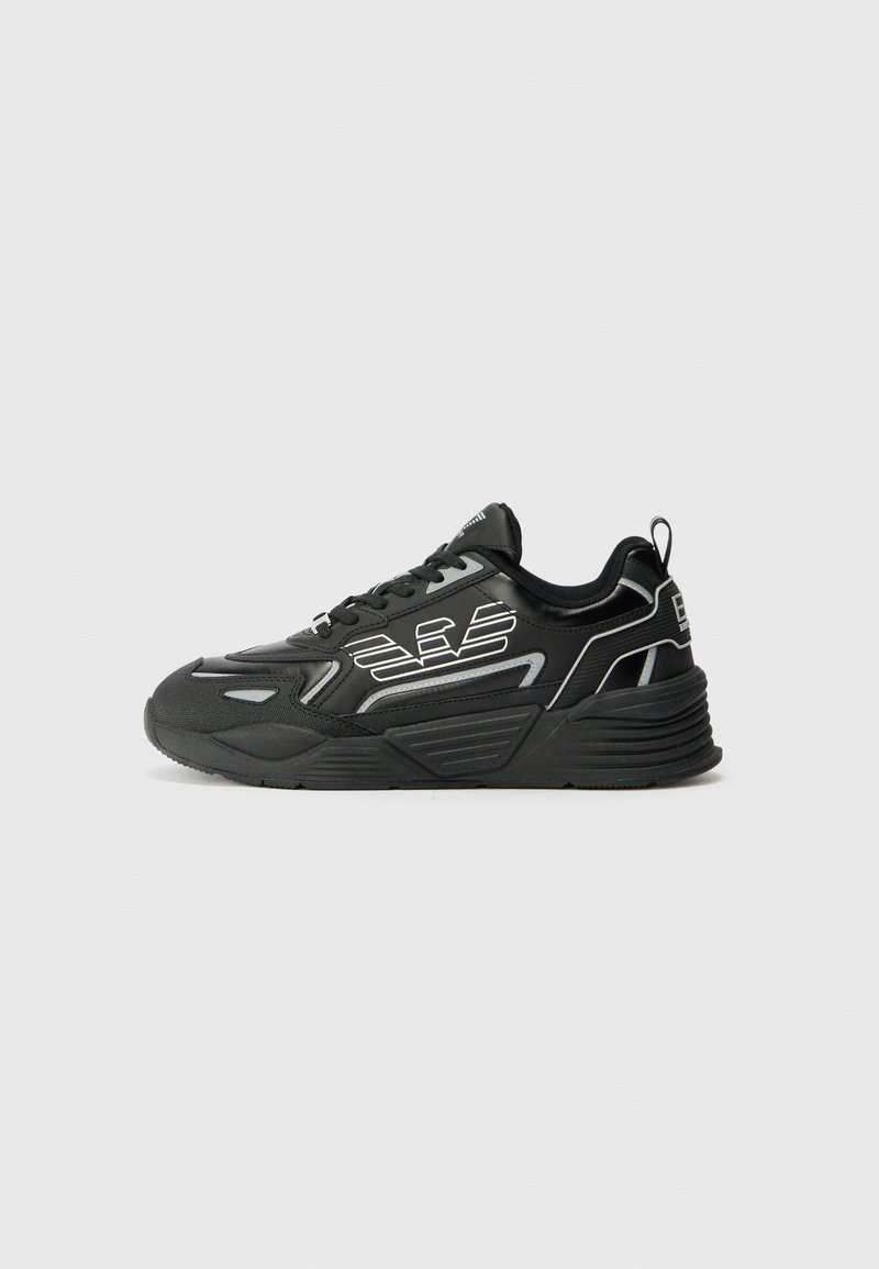 Black athletic shoe with a textured finish. Features a streamlined design, reflective accents, and a cushioned sole for support.