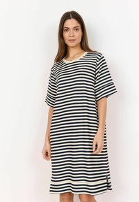Striped dress in cream and navy blue, short sleeves, loose fit, with side slits for ease of movement and a round neckline.