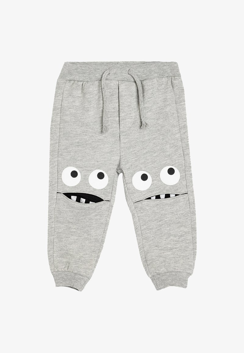 Graue Baumwollsweatpants mit elastischem Bund, die an den vorderen Taschen große Augen und Münder als Designelemente aufweisen; gerippte Knöchelbündchen.