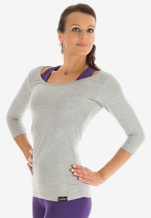 Gray long-sleeve top with a scoop neckline, featuring purple accents underneath. Soft fabric with a fitted shape and small brand label at the hem.