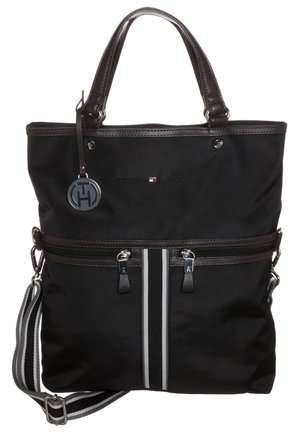 Czarna torba typu tote Tommy Hilfiger z podwójnymi uchwytami, regulowanym paskiem na ramię w paski, przednią kieszenią na zamek oraz zawieszką z logo na uchwycie.