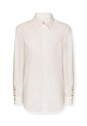 Camisa blanca de manga larga con cuello, textura suave y puños abotonados con detalles en tono dorado. Corte recto, diseño minimalista.