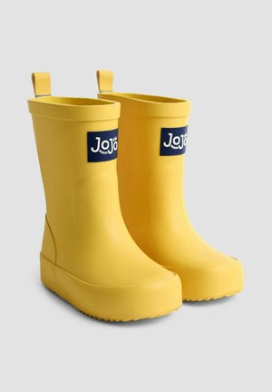 Gelbe Gummistiefel mit glatter Textur, abgerundeter Zehenform und einem Logo-Patch an der Seite. Mit Zuglaschen für ein einfaches Anziehen.