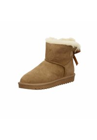 Bottine en suede brun avec une doublure en fausse fourrure blanche duveteuse, embout arrondi et un nœud décoratif à l'arrière. Semelle en caoutchouc texturé pour une bonne adhérence.