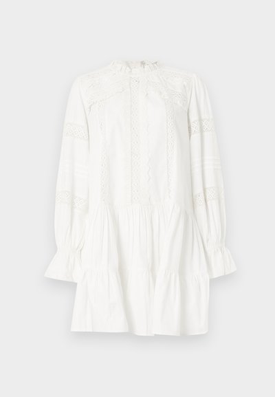 Λευκό μίνι φόρεμα με μακριά μανίκια και ψηλό γιακά, με δαντέλα στο στήθος και τα μανίκια, βολάν στις μανσέτες και φούστα σε στρώσεις με πιέτες.