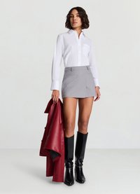 White button-up shirt with a pocket, gray mini skirt, red leather jacket, and knee-high black boots. Smooth textures and tailored fit.