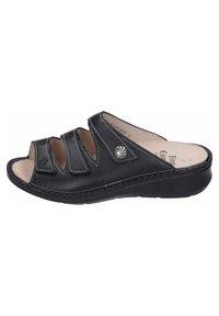 Black leather slide sandal with three wide straps, open toe, cushioned insole, and a slight wedge heel. Decorative silver logo on the side.