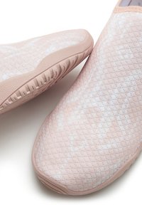 Light pink slip-on shoes with a textured upper featuring a geometric pattern. Rubber sole with grooves for traction. Smooth finish.