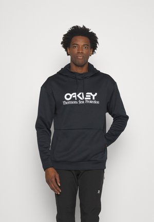 Navy hooded sweatshirt with white "Oakley" logo and "Thermonuclear Protection" text, featuring a kangaroo pocket and ribbed cuffs.