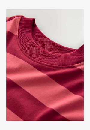 Close-up of a ribbed crew neck collar on a pink and red horizontally striped fabric garment.