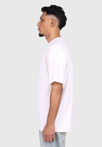 Hvid kortærmet t-shirt lavet af blødt bomuld. Løs pasform med rund halsudskæring og ingen synlige mønstre eller accenter.