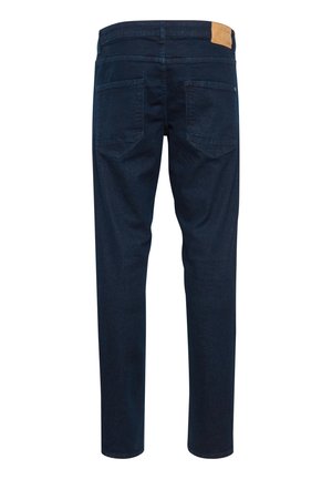 Dark blue denim jeans with a slim fit, featuring two back pockets, a leather patch on the waistband, and a smooth texture.
