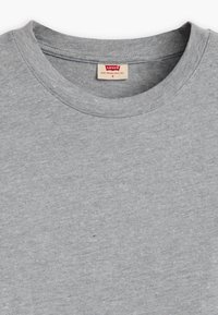 Light gray crew neck T-shirt with a small Levi's brand label sewn inside the collar, size small.