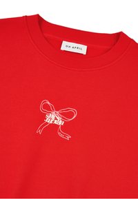 Červená mikina z bavlny s žebrovaným kulatým výstřihem. Na přední straně je bílý potisk mašle s textem. Na štítku je nápis "OH APRIL."