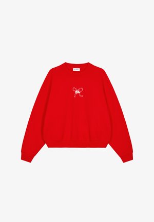 Rode sweatshirt met lange mouwen, geribde manchetten en zoom. Heeft een wit geborduurd strikontwerp aan de voorkant en een ronde hals.