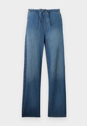Pantalon en denim bleu à jambes larges avec taille élastique et cordon, présentant un effet délavé sur le devant des jambes.