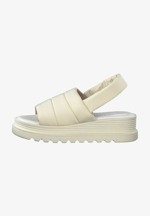 Cream-colored platform sandals with a padded strap design, open toe, and textured sole for grip. Features a cushioned heel for comfort.