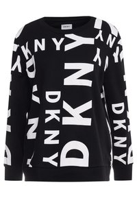Zwarte longsleeve trui met grote witte DKNY-logo's die in verschillende richtingen zijn gedrukt.