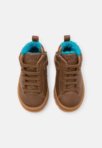 Brown leather shoes with a textured surface, featuring turquoise fleece lining and laces, round toe, and a rubber sole.