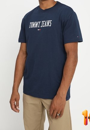 Navy blue cotton t-shirt featuring "TOMMY JEANS" in white text. Short sleeves, crew neck, with small logo detail on the left sleeve.