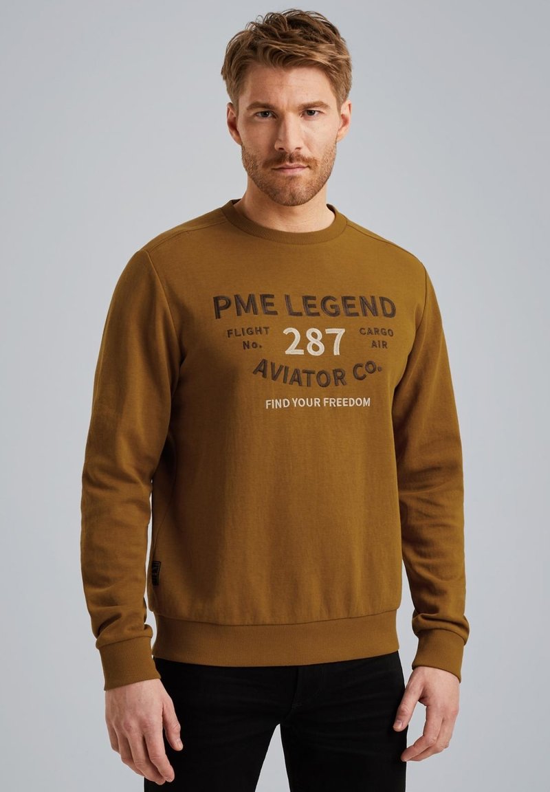 Bruine sweatshirt met een ronde hals, lange mouwen en een grafische print met tekstdetails. Gemaakt van een zachte, gestructureerde stof.