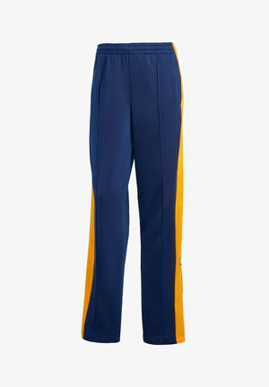 Marineblaue Sporthose mit gelben Seitenpanelen, elastischem Bund und schmal zulaufendem Bein. Hergestellt aus leichtem, atmungsaktivem Stoff.