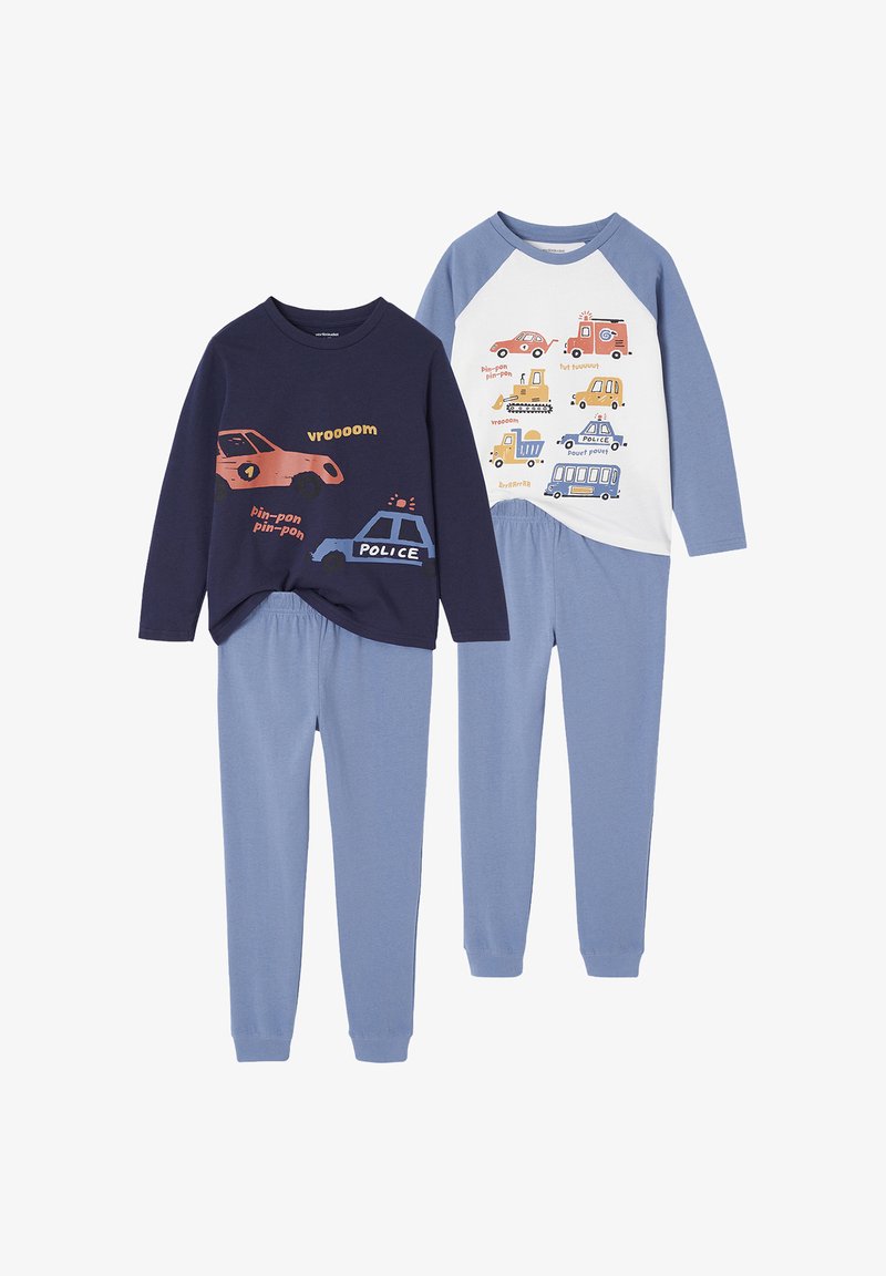 Two children's pajama sets with blue pants; one navy top with police and car illustrations, one white and blue top with various vehicle illustrations.