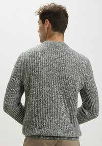 Maglione grigio lavorato a maglia con un motivo testurizzato, scollo a girocollo e polsini e orlo a coste, visto da dietro.