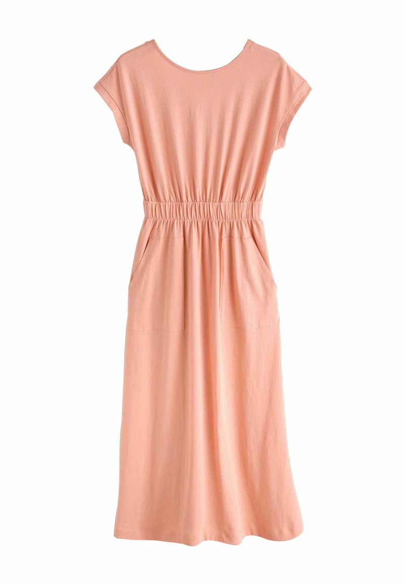 Peach-colored, short-sleeve dress with an elastic waist, side pockets, and a relaxed fit, made of soft fabric with a smooth texture.