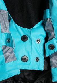 Veste turquoise avec une texture lisse et brillante, fermetures à boutons et doublure grise contrastante. Accent en métal noir remarquable.