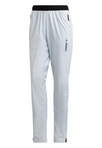 Pantalones de exterior de color gris claro con cintura elástica, bolsillos laterales con cremallera y detalles en negro. Fabricados con un tejido ligero apto para actividades.