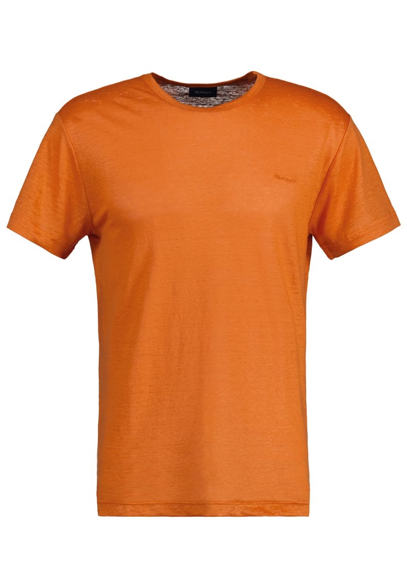 T-shirt arancione con colletto a girocollo realizzato in tessuto leggero. Maniche corte, texture liscia e un piccolo logo sul petto. Vestibilità classica.