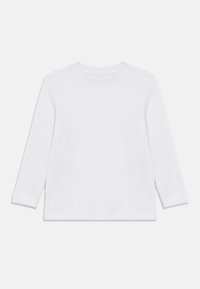 Άσπρο πουκάμισο μακρυμάνικο από απαλό βαμβάκι. Στρογγυλή λαιμόκοψη, απλός σχεδιασμός και ίσια τελείωμα με πλευρικές σχισμές. Χωρίς σχέδια ή εκτυπώσεις.