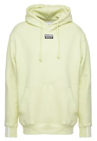 Světle žlutá mikina s kapucí vyrobená z měkké látky, s velkou přední kapsou, kapucí se stahovací šňůrkou a bílými pruhy na rukávech. Přítomná černá logo nášivka.