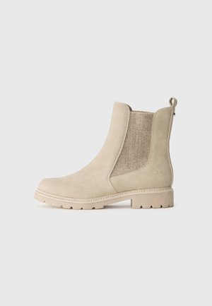 Beige semskede ankelstøvler med elastiske sidepaneler og en struktureret vævet detalje. Har en skridsikker sål og en hælløkke.