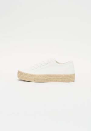White canvas sneaker with a round toe, lace-up front, and a jute-wrapped platform sole for added height. Smooth texture throughout.