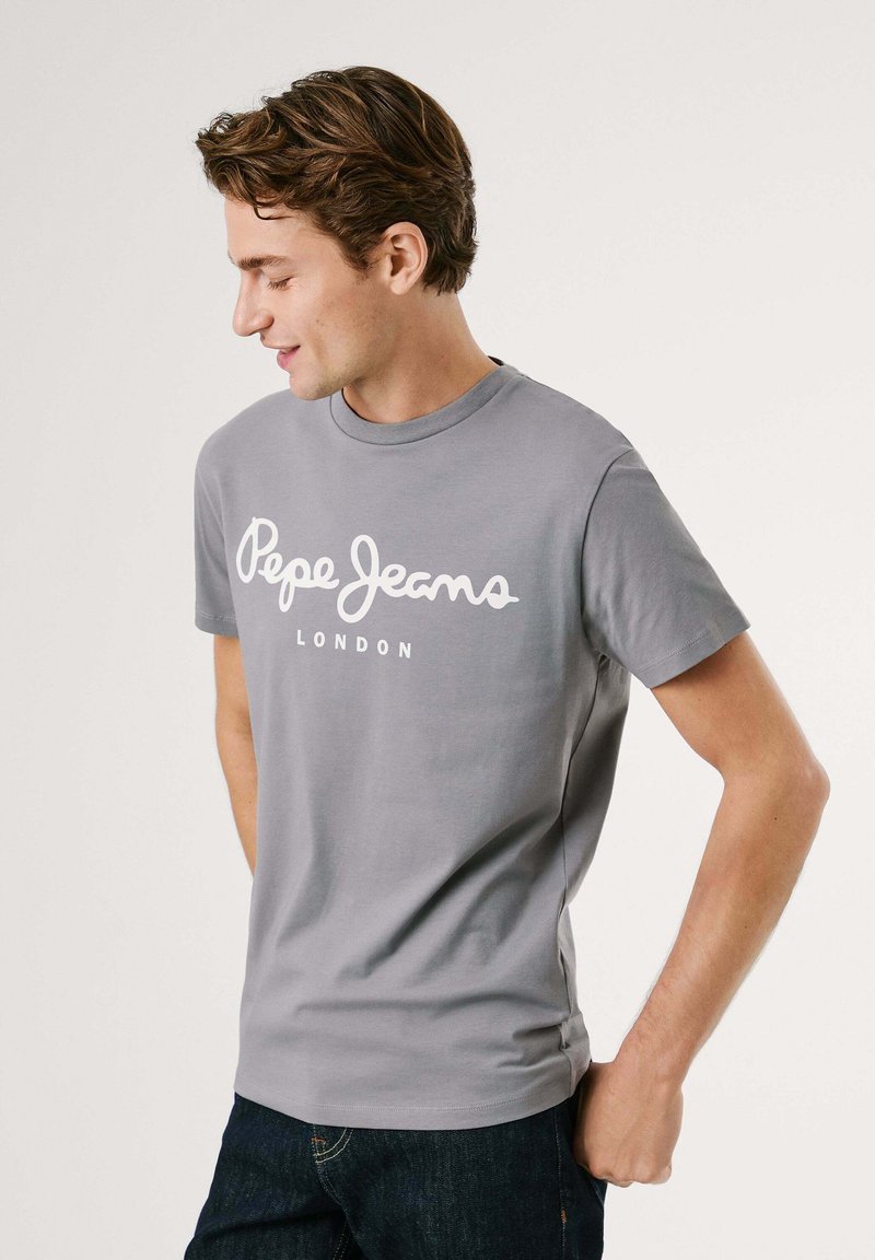 Graues T-Shirt mit kurzen Ärmeln aus Baumwolle, mit weißem "Pepe Jeans"-Logo und "LONDON"-Text auf der Vorderseite bedruckt. Rundhalsausschnitt und taillierte Passform.