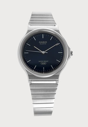 Ceas de mână Casio quartz argintiu cu cadran negru, markere subțiri argintii pentru ore, ace și brățară metalică, indicând ora 10:10:45.