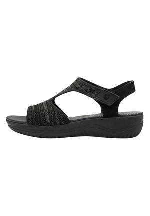 Sandal nera con tomaia intrecciata, punta aperta e cinturino alla caviglia regolabile. Presenta una soletta imbottita e suola in gomma leggera.