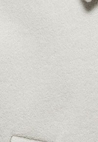 Light grey fabric with a soft, textured surface. Features a smooth, uniform appearance and shaped edge.