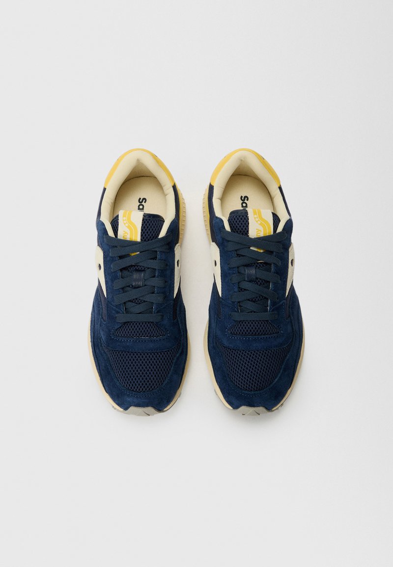 Sneakers blu navy realizzati in materiali mesh e suede, con un design a lacci, accenti crema e suola in gomma con una finitura testurizzata.