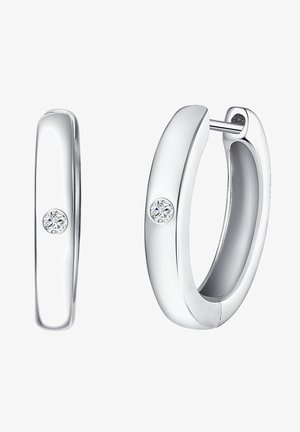 Pendientes de aro de plata con un acabado pulido, que cuentan con un pequeño acento de diamante redondo en cada pendiente. Diseño liso y redondeado.