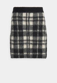 Minijur med ullblandning som har ett svartvitt rutmönster, mjuk textur och svart midja.