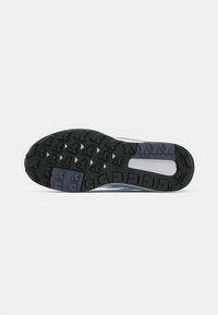 Shoe outsole features a black rubber base with deep tread patterns, grey and blue accents, and a textured finish for traction.