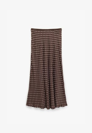 Jupe marron, longueur genou, en tissu doux, avec un motif de pois blancs sur toute sa surface. Design évasé avec une taille élastique.