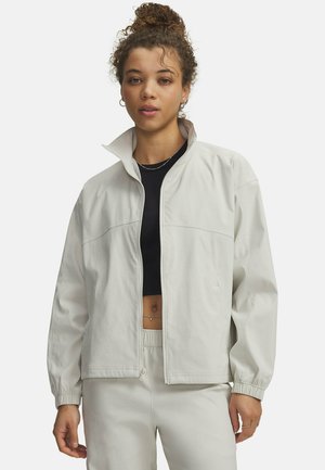 Light gray, lightweight jacket with a high collar, front zipper, and elastic cuffs; features a relaxed fit and smooth texture.
