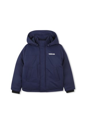 Veste matelassée bleu marine avec capuche, présentant une fermeture éclair à l'avant, deux poches latérales et le logo Timberland sur la poitrine.