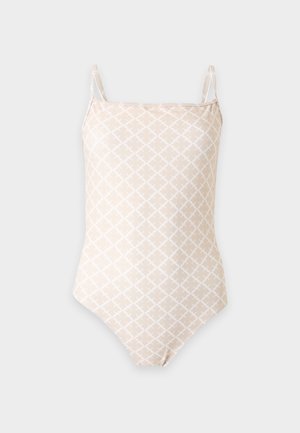 Maillot de bain une pièce beige avec fines bretelles et un subtil motif géométrique blanc sur le tissu.